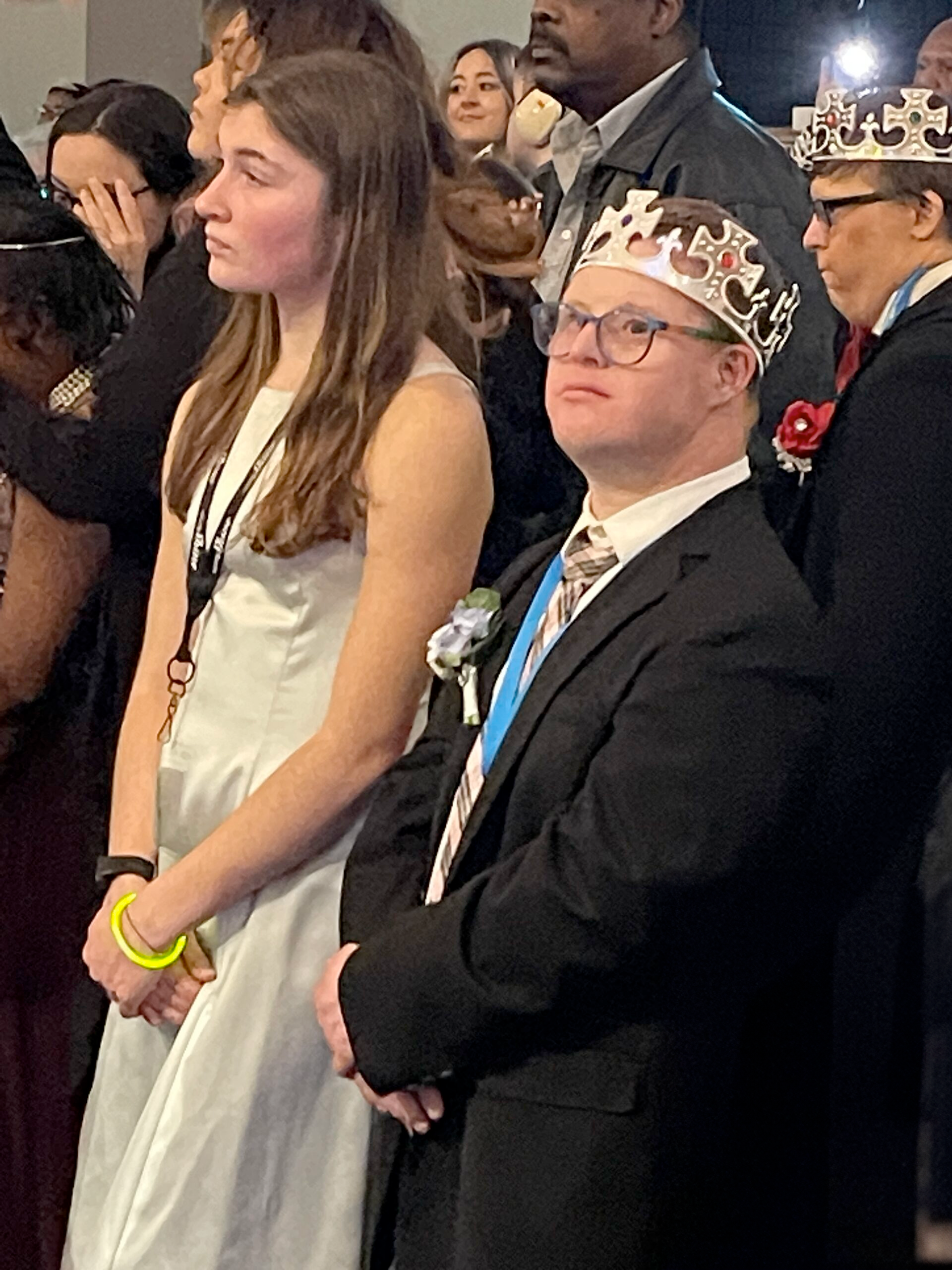 Young man and woman standing listening to an announcement